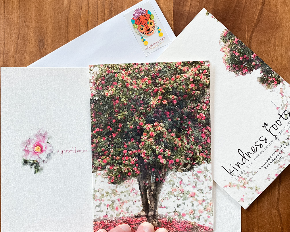 Gratitude card shown with front, back, and inside with camellia flower details and envelope with a Year of the Tiger stamp.